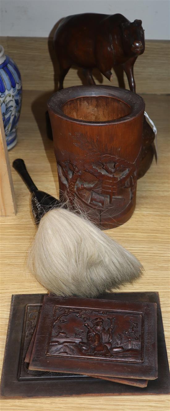 A Chinese bamboo brushpot, a calligraphy brush, a wooden ox and four carved wood panels